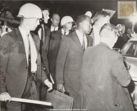 James H. Meredith, the first African American student admitted to the segregated University of Mississippi Oxford, Miss., sept. 30. Meredith under escort. James H. Meredith, a Negro, right center, is escorted by federal marshals as he arrived at Oxford, Miss. tonight for registration at Ole Miss