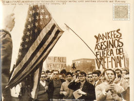 Madrid University Students waving anti american placards and Vietcong flags burn U. S. flag on University campus