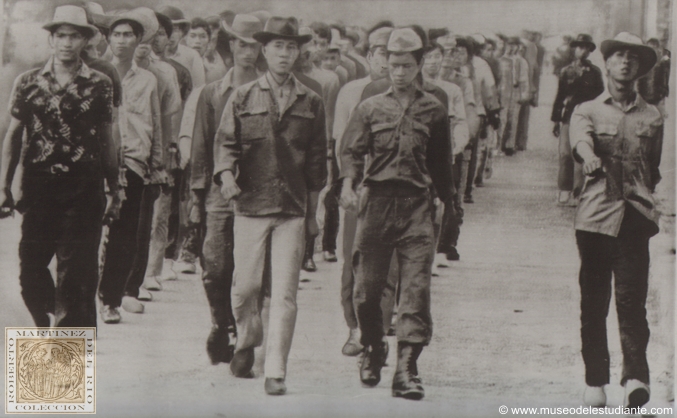 Students heed their country's call. Cambodian university students, some wearing fatigue uniforms, march towards barracks in Phnom Penh Saturday following a drill at a near, by parade ground. Many of the nation's university and high school students have volunteered for militia units and para military units recently