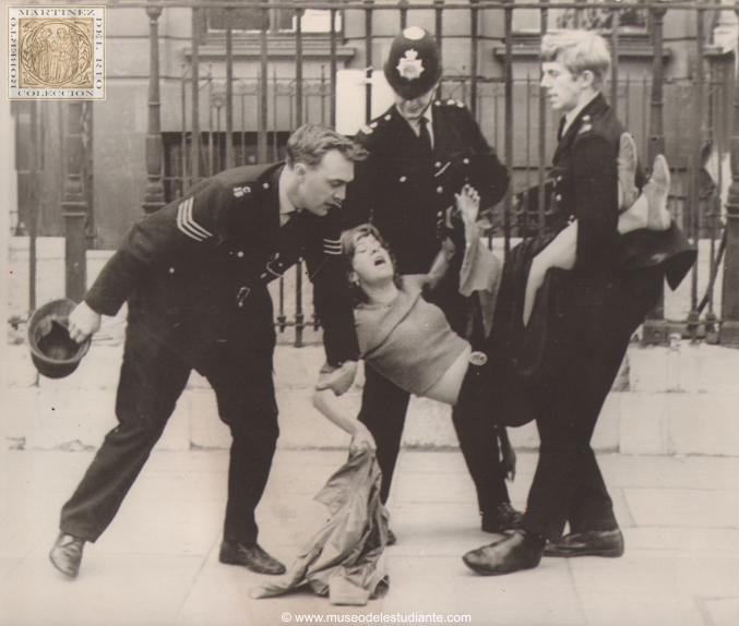 London, September 21 (AP) - Squatters evicted from Picadilly Mansion. Three London policemen carry a struggling girl from the hundred room mansion in London's Picadilly today. The Georgian mansion had been occupied by squatters since last sunday