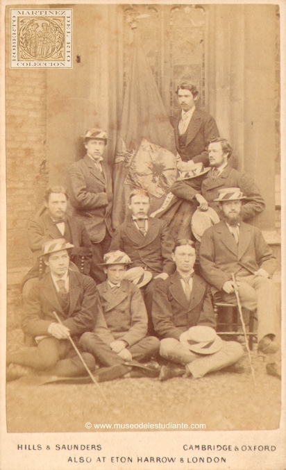 A group of Cambridge students with the flag of the Queen's College