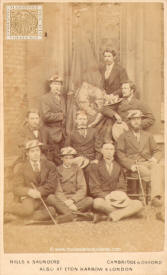 A group of Cambridge students with the flag of the Queen's College