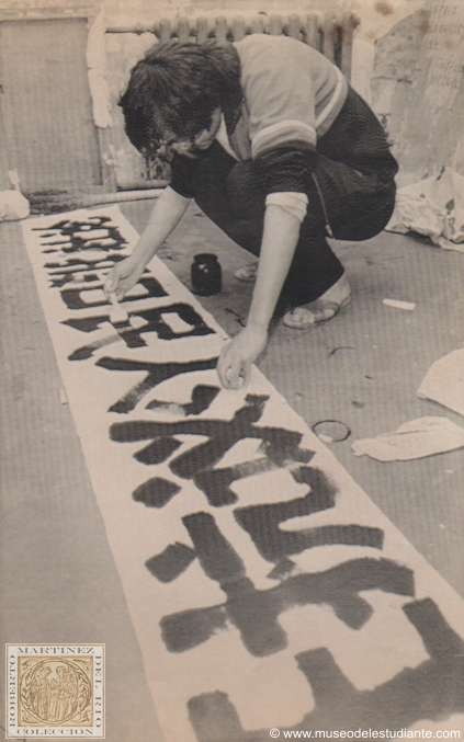 Beijing, May 13. March preparations. A student activist at Beijing University paints a banner for the May 4th march wednesday night in a campus dormitory room